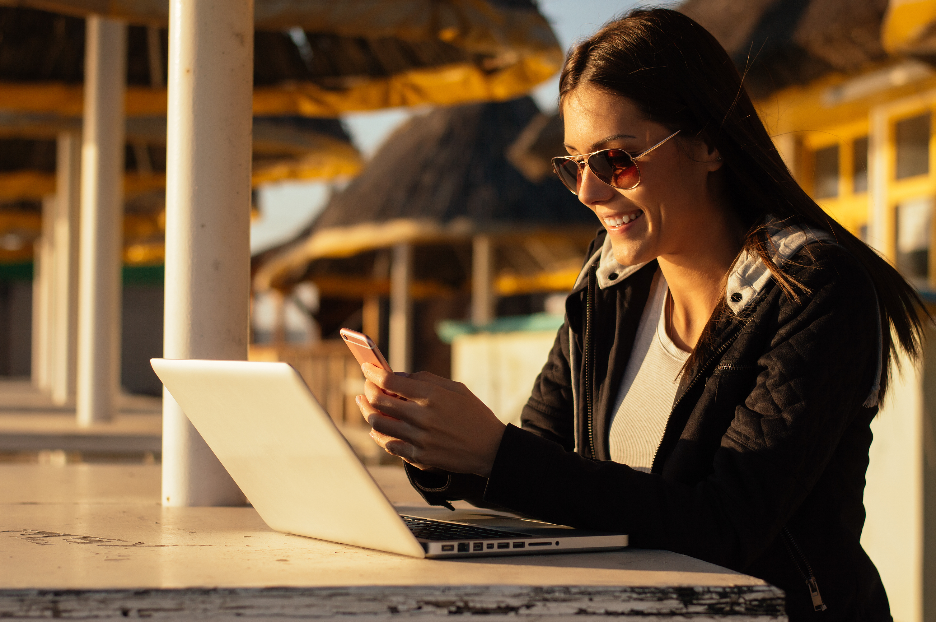 Beautiful girl reading a message on a beach